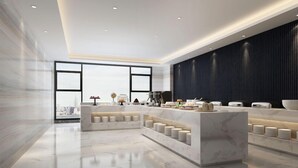 A modern hotel lobby with marble flooring, a central reception desk, and a large window offering a city view. - Paco Hotel (Guangzhou)