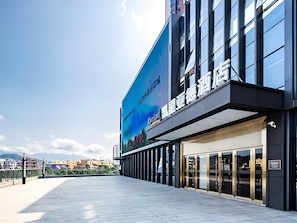 A hotel facade with large windows and a prominent outdoor area. - Kyriad Marvelous Hotel Shenzhen Liuyue Metro Station (Shenzhen)