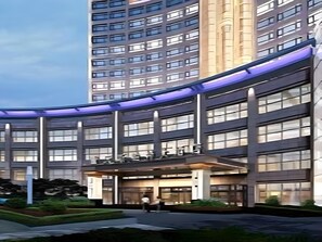 A multi-story hotel with a curved facade, large windows, and a central entrance. - Sport Hotel (Chongqing)