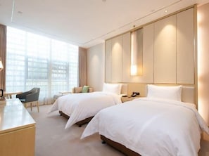 A hotel room with two beds, a desk, a chair, and a large window. - Begonia Hotel (Suzhou)