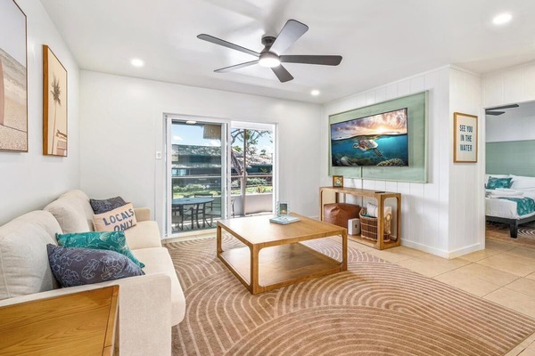 Step into your serene coastal retreat where natural light and ocean breezes flow freely. Sink into the plush sofa, feel the cool air from the ceiling fan, and gaze out at the sunny balcony—your peaceful escape awaits.