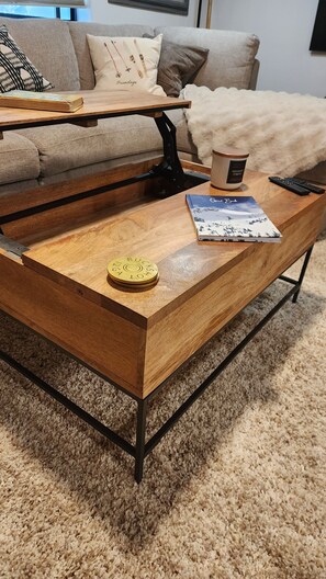 A wooden coffee table with a remote control and a book on it. - Fully Remodeled 2Bed 2Bath Downtown Condo 3 Blocks From Lake Walk to Everything (McCall)