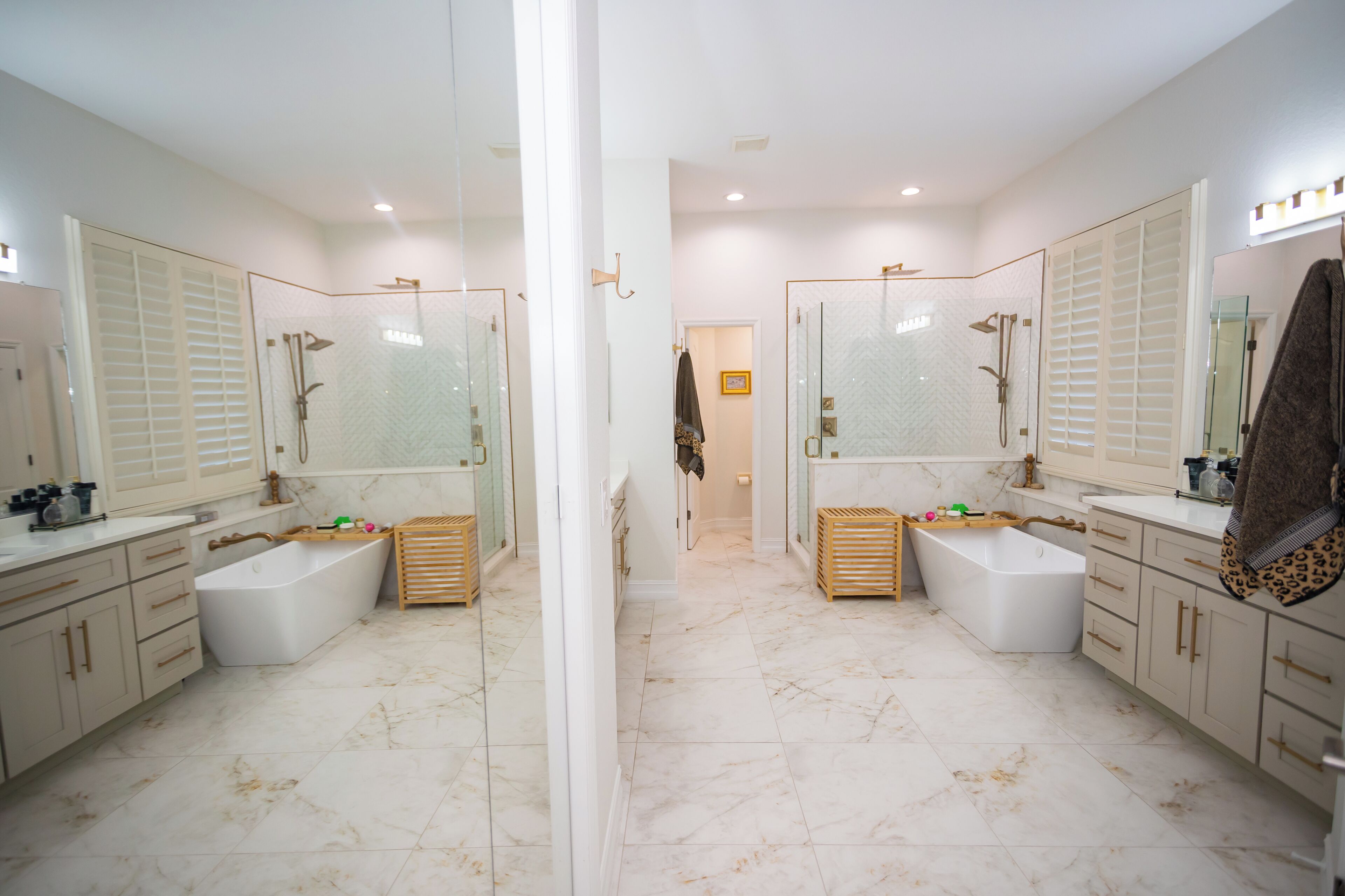 A modern bathroom with two sinks, a shower, and a glass-enclosed shower area.