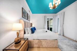 A modern bedroom with a bed, a bedside table, a lamp, and a ceiling light fixture. - StayShort - Comfortable 1 bedroom in Marina with Balcony! (Dubai Marina)