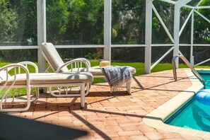 A poolside area with lounge chairs and a pool. - Family‑Friendly Tropical Beach Home w/ Private Pool ☀️ (Indian Harbour Beach)