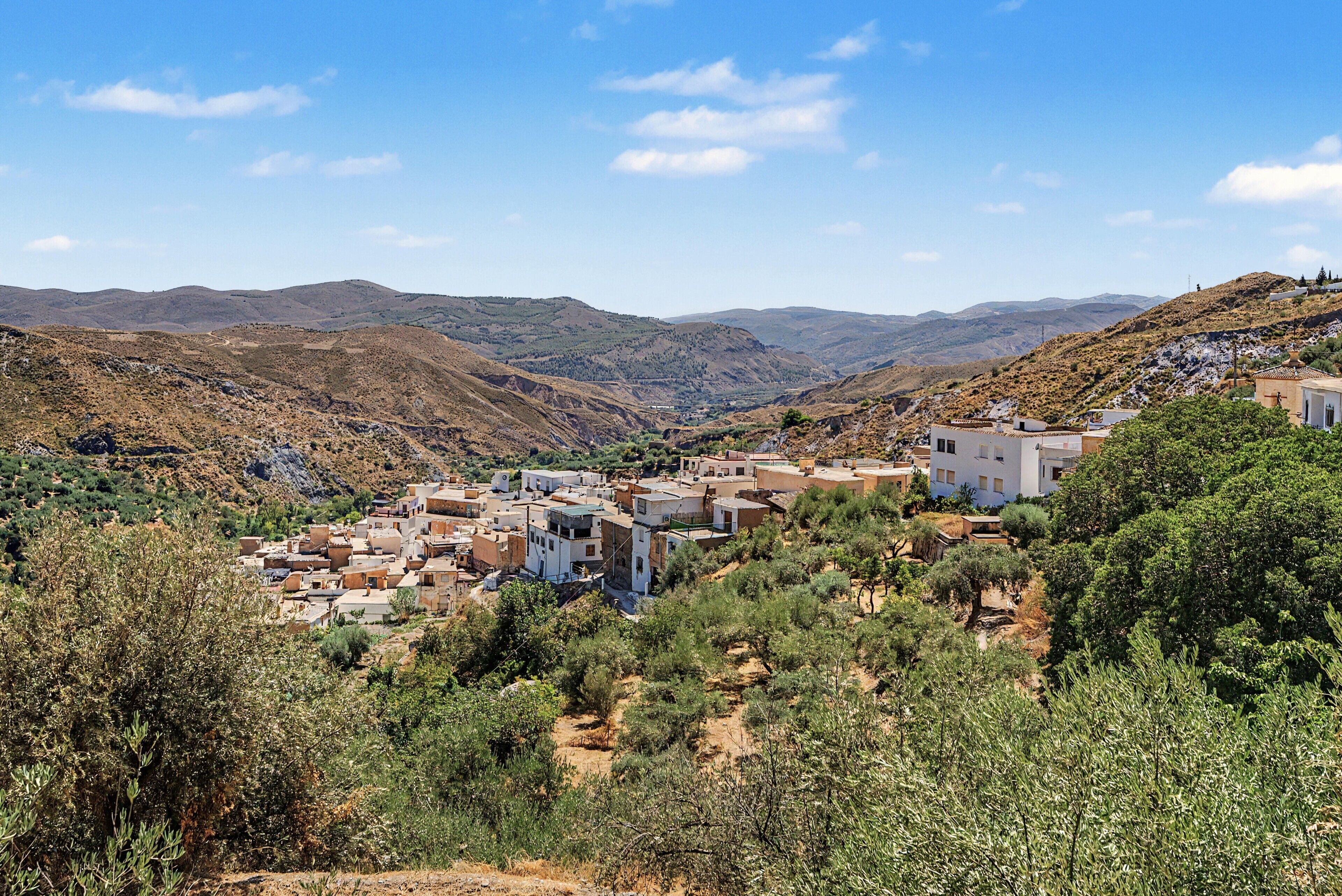 A mountainous village with traditional buildings and a clear sky.