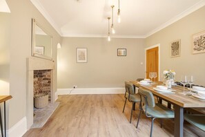 Spacious dining room with feature fireplace and contemporary dining space. - The Old Forge - North East Escapes (Warkworth)
