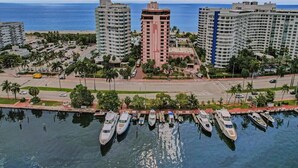 A marina with yachts docked, surrounded by high-rise buildings and a clear view of the ocean. - Bay & Ocean View 4 BDR Spacious Condo Resort Amenities 1616 (Miami Beach)