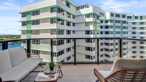 A modern multi-story building with balconies, a pool, and a view of the landscape. - Bay & Ocean View 4 BDR Spacious Condo Resort Amenities 1616 (Miami Beach)