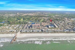 An aerial view of a coastal town with a large hotel, a pier, and a beach. - Tilghman Shores I6- 2 Bedroom- Pool, Hot Tub (North Myrtle Beach)