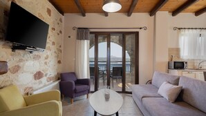 A living room with a sofa, armchairs, a TV, and a balcony with a view. - Villa Koule - Three Bedroom Villa, Sleeps 6 (Kalami)
