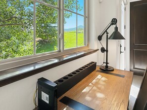 A room with a large window, a desk with a computer, and a lamp. - Family Neighborhood Nestled In Nature (Park City)