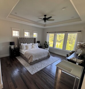 A bedroom with a large bed, a ceiling fan, and multiple windows. - MIZ-ZOU football weekend home
Awesome  house on Hole #7 at Old Hawthorne (Columbia)
