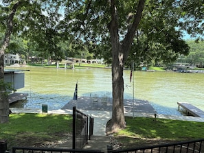 A lakeside park with a gazebo, a dock, and a flagpole. - Spacious 4-bedroom home on beautiful Lake McQueeney with water access! (McQueeney)