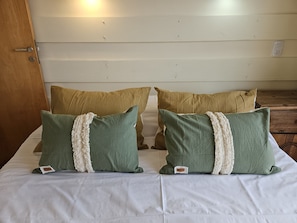 A bed with two pillows and a wooden door. - Lake and City steps from the Centro Civicoc (San Carlos de Bariloche)