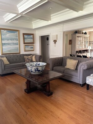 A living room with two grey sofas, a wooden coffee table, and a large decorative bowl. - THE PERFECT SUMMER HOME Tranquil 3-bedrooms home in charming Rumson NJ (Rumson)