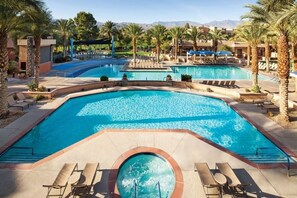 A resort pool area with multiple pools, sun loungers, and palm trees. - 1 BR Shadow Ridge Villa during Coachella Music Festival (Palm Desert)