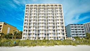 A multi-story hotel with balconies, located near a beach. - Your Beachfront Getaway Awaits at Myrtle Beach SC (Myrtle Beach)