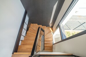 A spiral staircase with wooden steps and metal railings, leading to a higher floor. - Villa Les Patys (Vouvray)