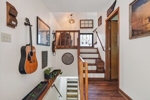 A staircase with wooden steps and a handrail, leading to a landing with a view of a window. - View of Sunset Marina and Dale Hollow Lake (Byrdstown)