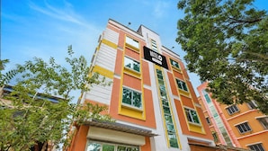 A multi-story hotel building with a prominent 'HOTEL' sign. - Deluxe With Twin Bed Ayush Villa (Kolkata)