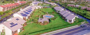 A residential area with multiple houses, a swimming pool, and solar panels on the roofs. - 4BR for 12, 2 Condos - Hale Kamaole, Kihei! (Kihei)