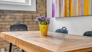 A wooden table with a yellow flower pot on it.