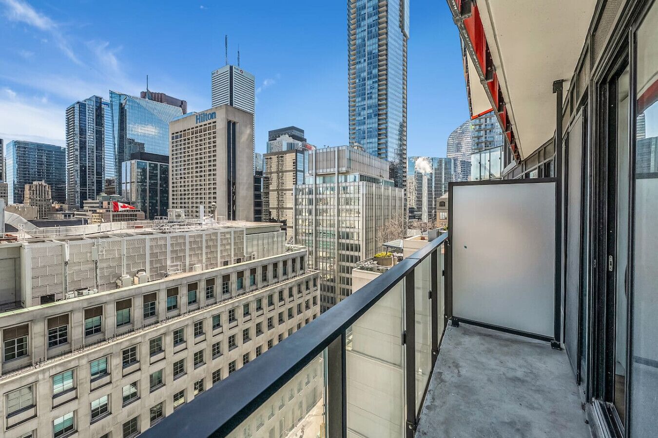 Een hoog gebouw met uitzicht op een stadsbeeld, waaronder een Hilton hotel.