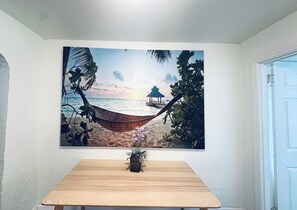 A beach scene with a hammock, palm trees, and a hut. - Serene 3-bedroom house with AC in charming St. Petersburg (St. Petersburg)