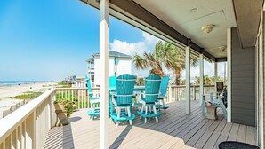 A wooden deck with outdoor seating and a view of the beach. - Close to the Sand w/ Showstopping Views & Wonderful Amenities - Dog Friendly! (Galveston)