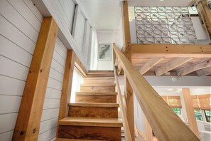 A wooden staircase with a railing, white walls, and a decorative ceiling panel. - North Georgia Luxury Treehouse Minutes to Lake Burton and Downtown Clayton GA (Clayton)