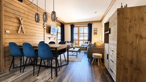 A wooden interior with a dining area, sofa, and cabinets. - Arcs 1950 • The Alpine Workshop • Mountain view * Hameau du Glacier 313 (Bourg-Saint-Maurice)