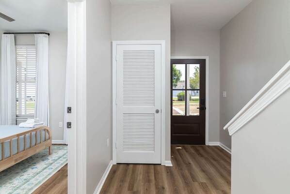 A bedroom with a bed, a door, and a view of the outside. - The Dolly (Oxford)