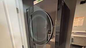 A compact, modern kitchen with a built-in dishwasher and a small refrigerator. - Modern 1BR Bridge Park in Dublin with Balcony and Pool (Dublin)