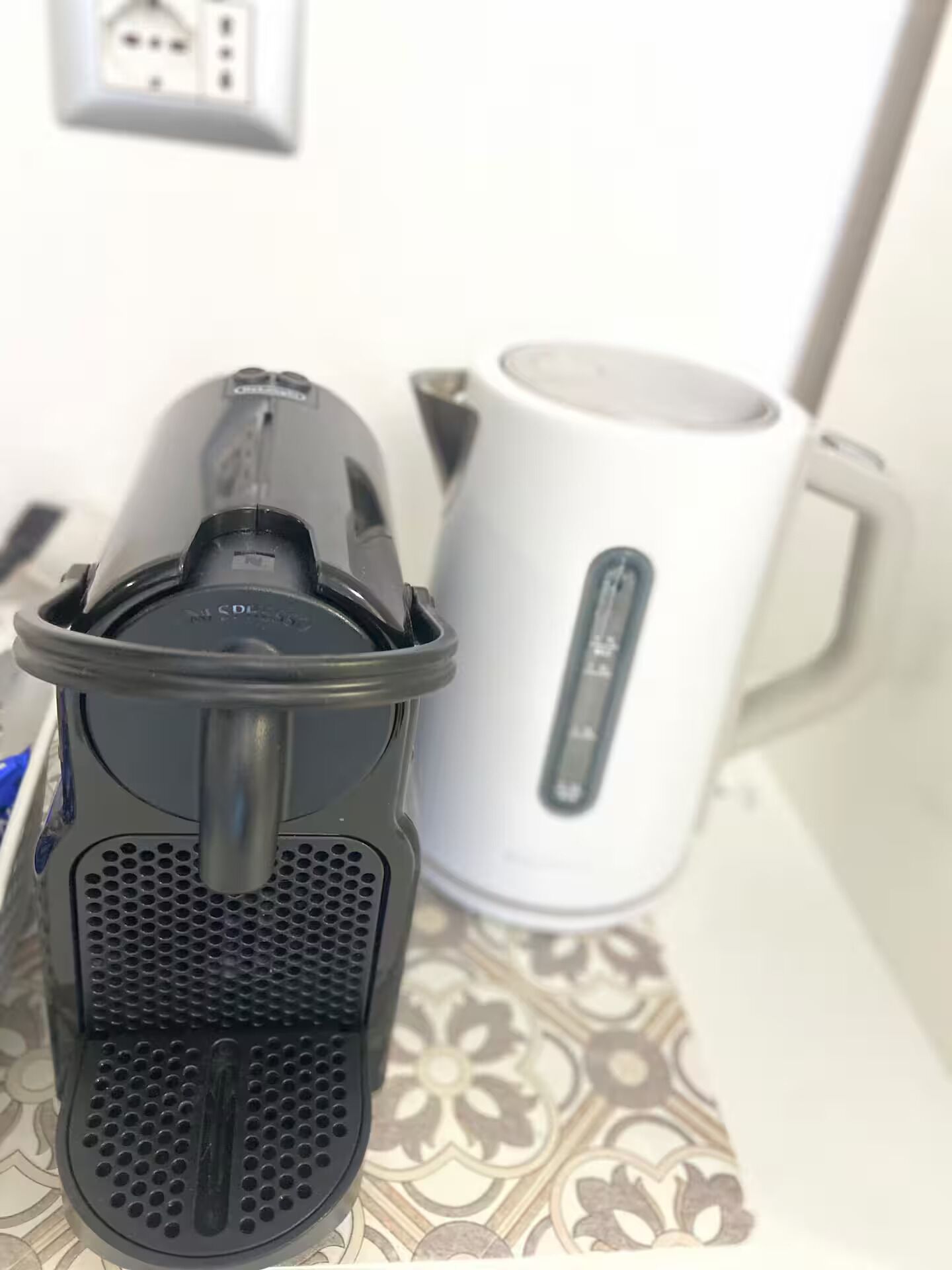 Ein Wasserkocher und eine Kaffeemaschine auf einem Tisch.