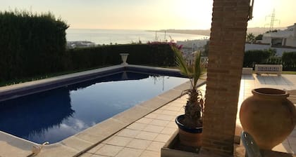 Panoramic views of the sea, harbor, and mountains. 500m from the beach