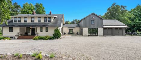 A two-story house with a driveway and a garage.