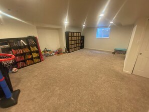 A room with a basketball hoop, bookshelves, a window, and a door. - Private Boulder Guest Suite with Kitchen, Near Trails & Downtown (Boulder)