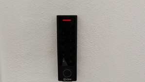 A wall-mounted electronic device with a numeric keypad and a CDVI logo, next to a white wall switch. - A brand-new facility in the center of Pulsano (TA), opening in July 2026! (Pulsano)