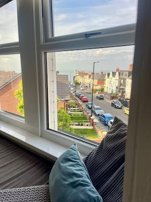 A window with a view of a residential street.
