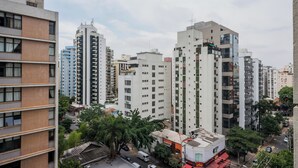 A high-rise building with multiple floors, large windows, and a flat roof. - Advance by Bhomy (São Paulo)