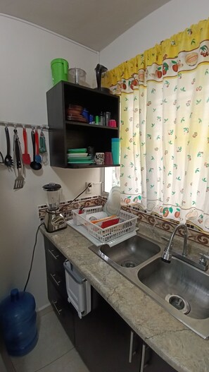 A kitchen with a sink, countertop, and various utensils. - A nice, cozy apartment with air conditioning. (Ecoterra Paraíso)