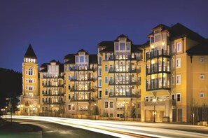 A multi-story hotel with balconies, a tower, and a well-lit facade. - Ritz-Carlton Vail Luxury 3BR/3.5 BA+Full Kitchen. Direct Access to Slope (Vail)