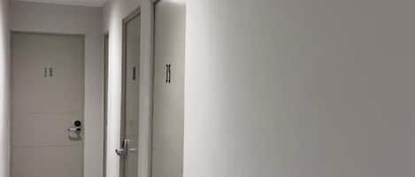 A hallway with doors numbered 33 and 34, and a directional sign on the wall.