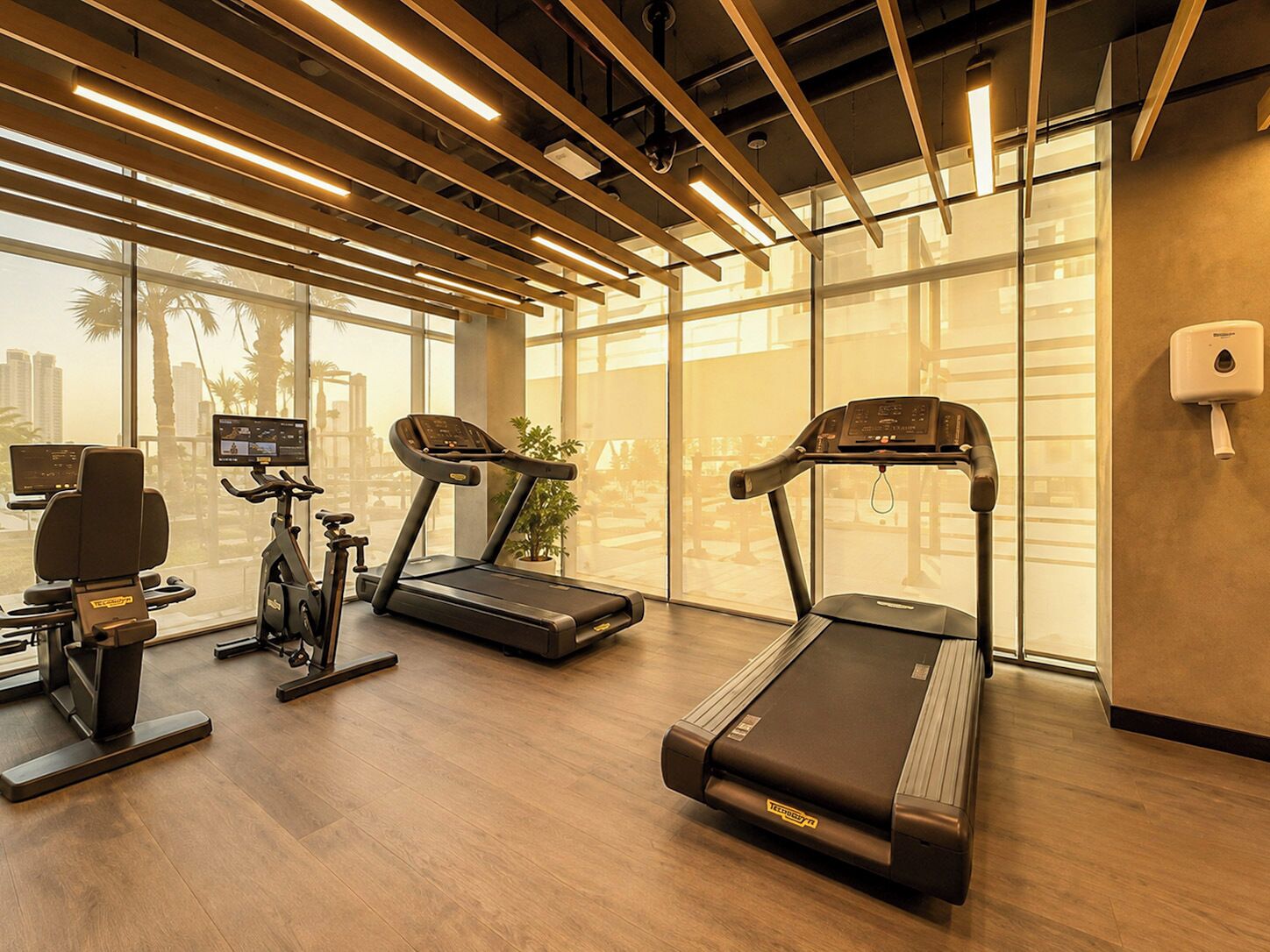 A gym with treadmills, an elliptical, and a stationary bike.