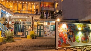 A building with multiple floors, a staircase, and a ground-level entrance with a colorful mural. - Ocean Reach Holidays (Mirissa)