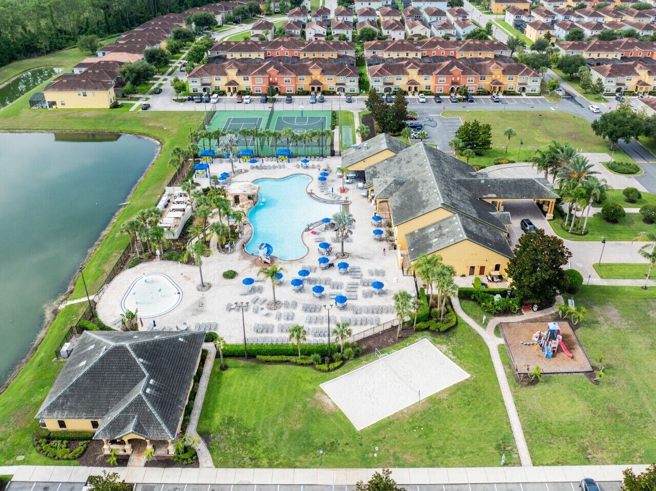 A residential area with a swimming pool, tennis courts, and a playground.