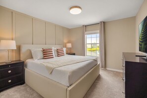 A hotel room with a large bed, two bedside tables with lamps, a dresser, and a window with curtains. - 4 BD/ 3 BA/ Storey Lake (4796 CT) (Kissimmee)