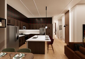 Une cuisine moderne avec un îlot central, des meubles en bois foncé et un pare-feu rouge à carreaux.