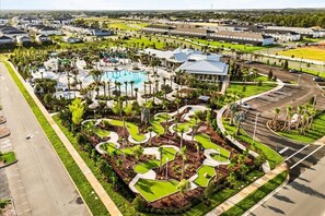 An aerial view of a resort with a swimming pool, landscaped areas, and a parking lot. - 10 BD/ 8 BA/ Windsor Cay (16224 SM) (Clermont)